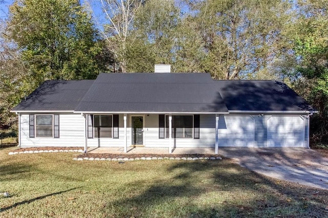 view of front of house featuring covered porch, a garage, and a front yard