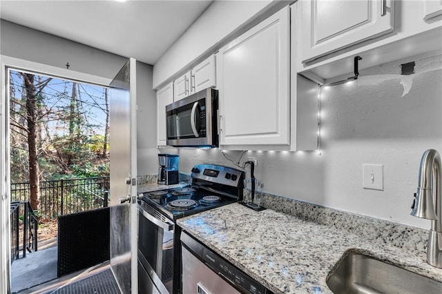 kitchen featuring white cabinetry, sink, a healthy amount of sunlight, and appliances with stainless steel finishes