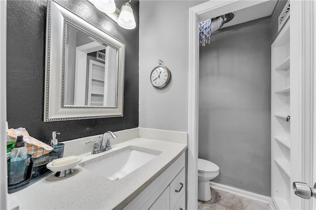 bathroom featuring vanity and toilet