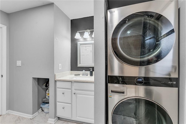 laundry room with stacked washing maching and dryer and sink