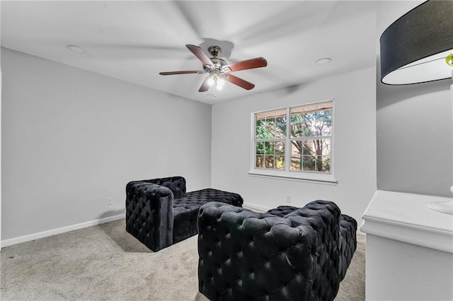 sitting room with carpet flooring and ceiling fan