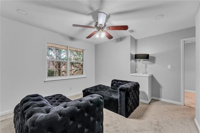 carpeted living room with ceiling fan