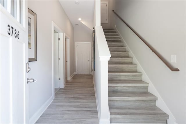 staircase with hardwood / wood-style floors