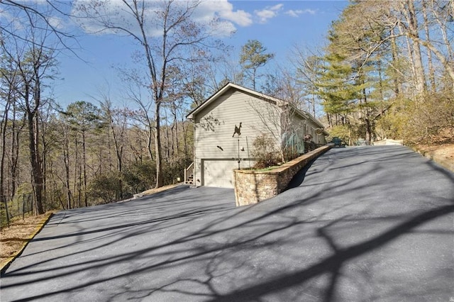 71 Yellow Root Dr, Big Canoe, GA 30143 - view of side of property featuring asphalt driveway and an attached garage