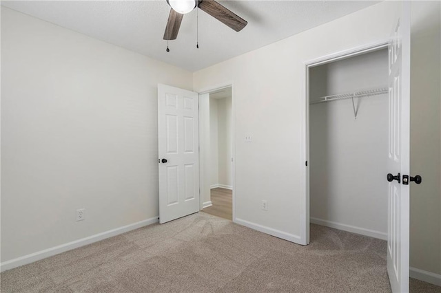 unfurnished bedroom featuring carpet flooring, baseboards, and a closet