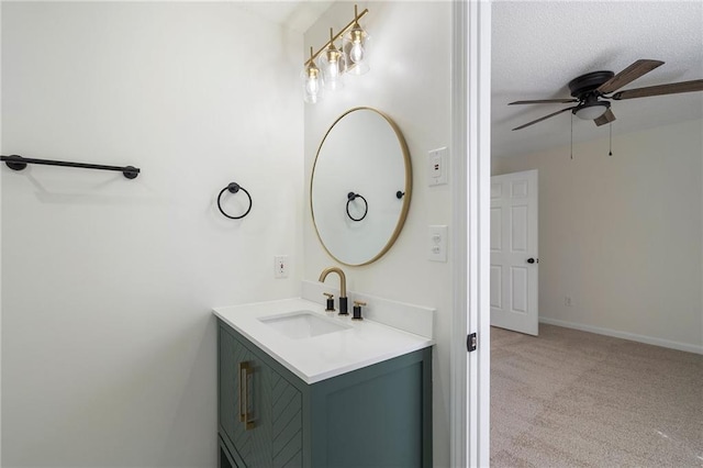 bathroom with baseboards, vanity, and a ceiling fan