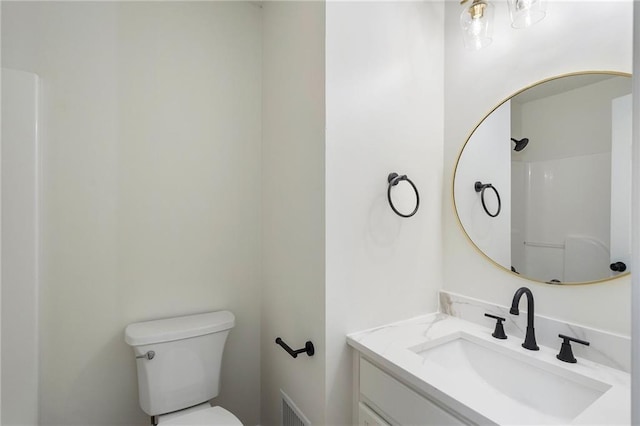 bathroom featuring visible vents, toilet, and vanity