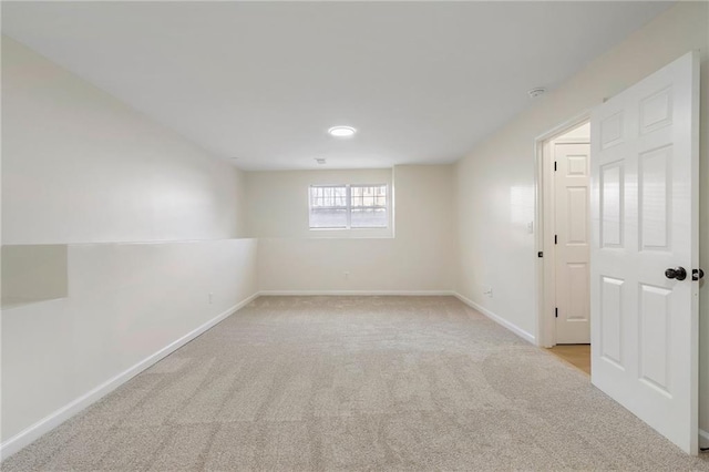 empty room featuring baseboards and carpet floors