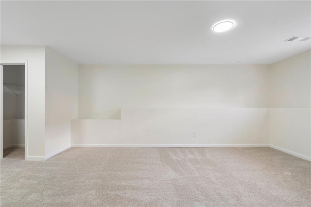 carpeted empty room featuring visible vents and baseboards