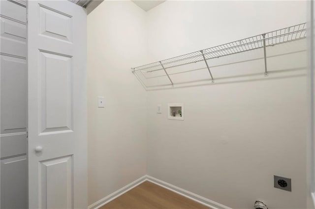 laundry room featuring baseboards, washer hookup, laundry area, wood finished floors, and electric dryer hookup