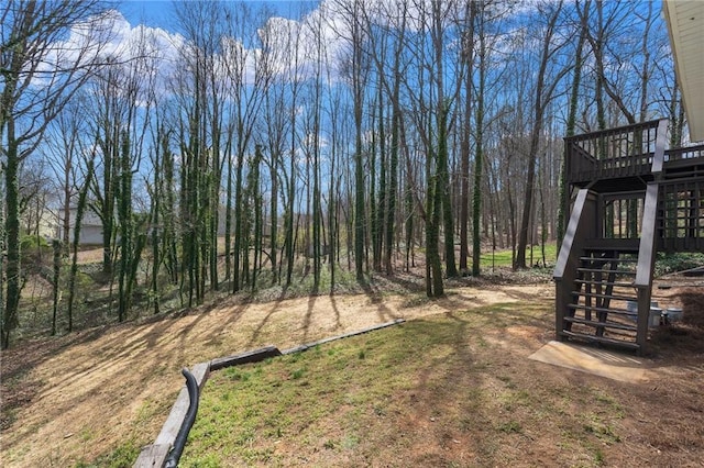 view of yard featuring a deck and stairs