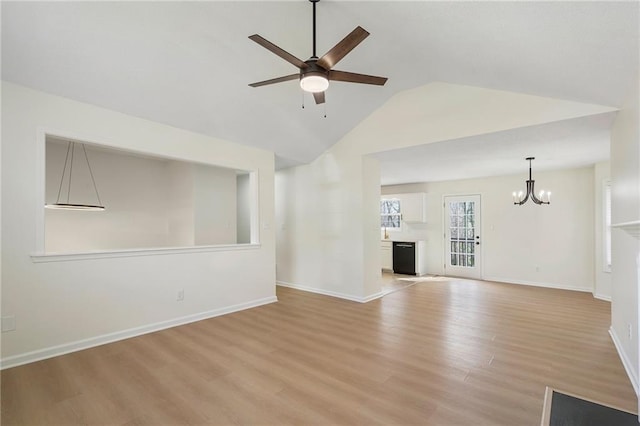 unfurnished living room featuring vaulted ceiling, ceiling fan with notable chandelier, light wood-type flooring, and baseboards