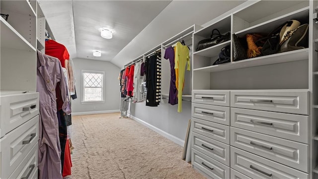 spacious closet with vaulted ceiling and carpet flooring