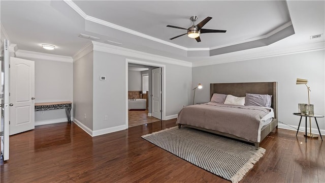 bedroom featuring visible vents, crown molding, a raised ceiling, and wood finished floors