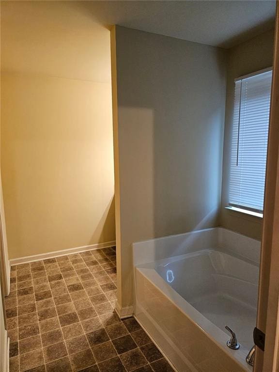 bathroom with a tub to relax in