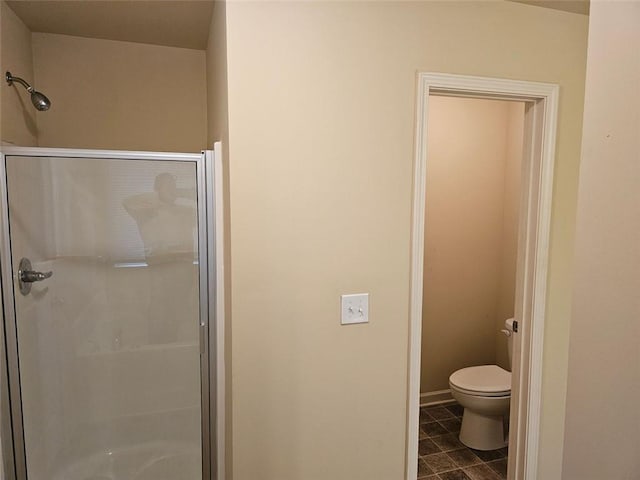 bathroom with an enclosed shower and toilet