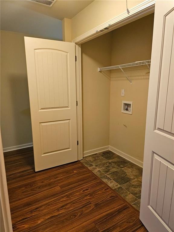 laundry room featuring dark hardwood / wood-style flooring and washer hookup