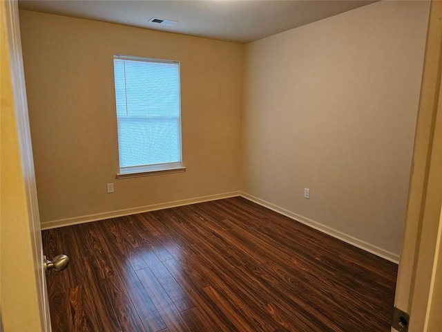 spare room with dark hardwood / wood-style flooring