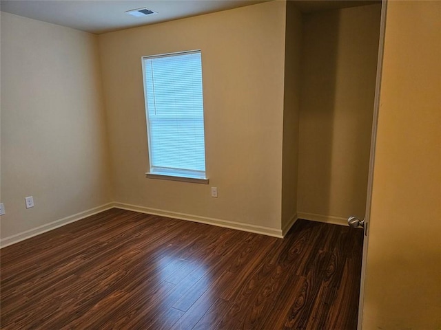 empty room with dark hardwood / wood-style floors