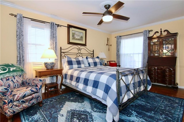 bedroom featuring ornamental molding, ceiling fan, and wood finished floors