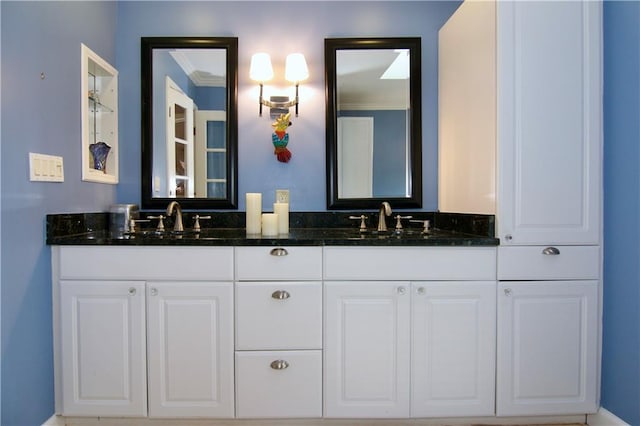 full bath featuring double vanity, crown molding, and a sink