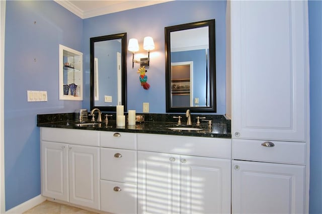 full bath with a sink, ornamental molding, and double vanity