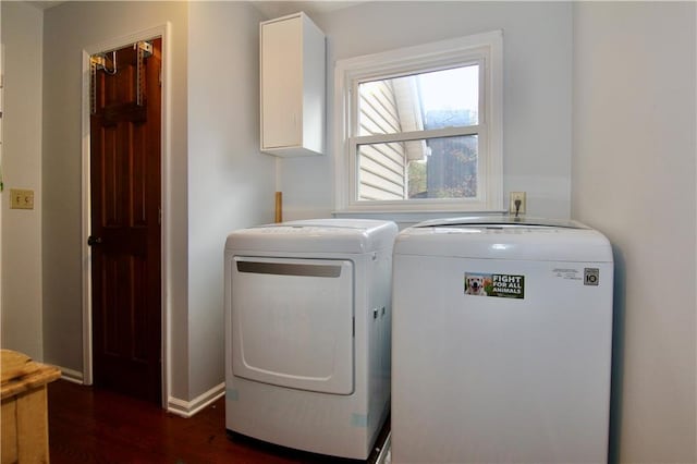 laundry room featuring dark wood-style floors, cabinet space, washer and dryer, and baseboards