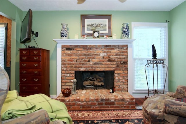 living area featuring a brick fireplace