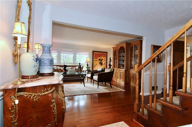 interior space featuring stairway, a textured ceiling, and wood finished floors