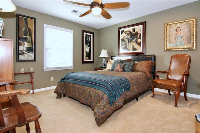 carpeted bedroom featuring visible vents, ceiling fan, and baseboards