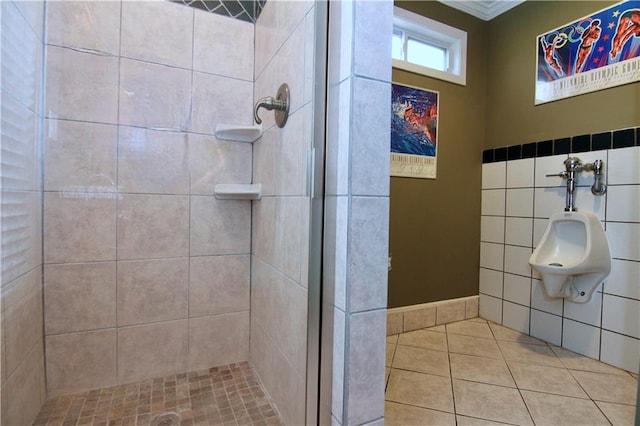 bathroom featuring tile walls, a stall shower, and tile patterned floors