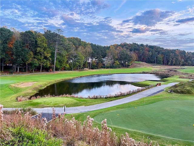 surrounding community with a yard and a water view