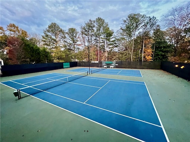 view of tennis court with fence