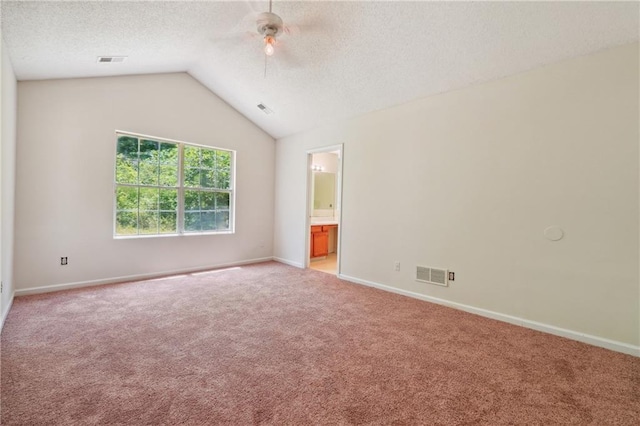 6445 Marsham Dr, Atlanta, GA 30349 - unfurnished room featuring light colored carpet, lofted ceiling, ceiling fan, baseboards, and a textured ceiling