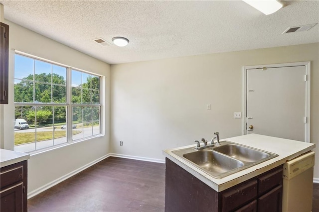 6445 Marsham Dr, Atlanta, GA 30349 - kitchen featuring dishwasher, a sink, dark brown cabinetry, a textured ceiling, and dark wood-style flooring