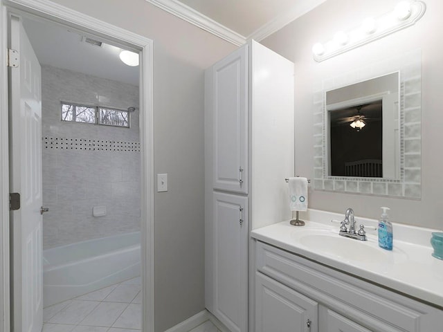 bathroom featuring vanity, crown molding, tile patterned floors, and tiled shower / bath combo