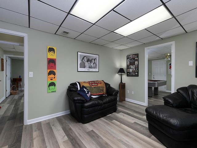 living room featuring a drop ceiling, light hardwood / wood-style floors, and billiards