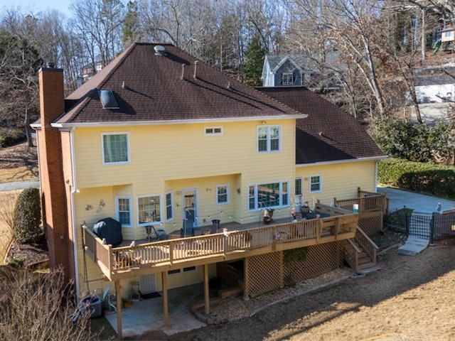 rear view of house with a wooden deck