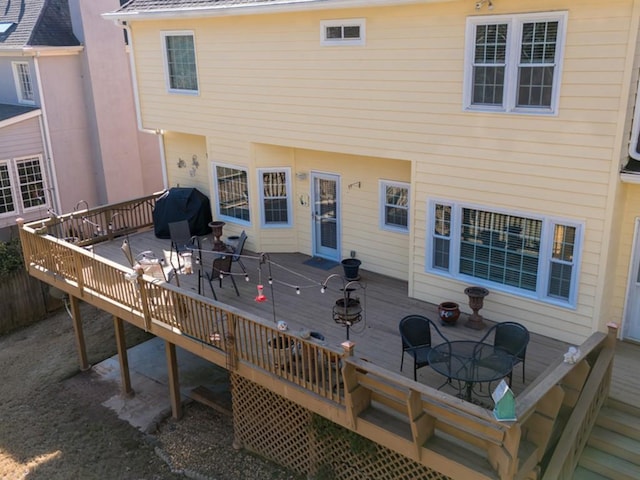 rear view of house featuring a deck