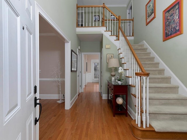 foyer featuring light hardwood / wood-style floors and a high ceiling