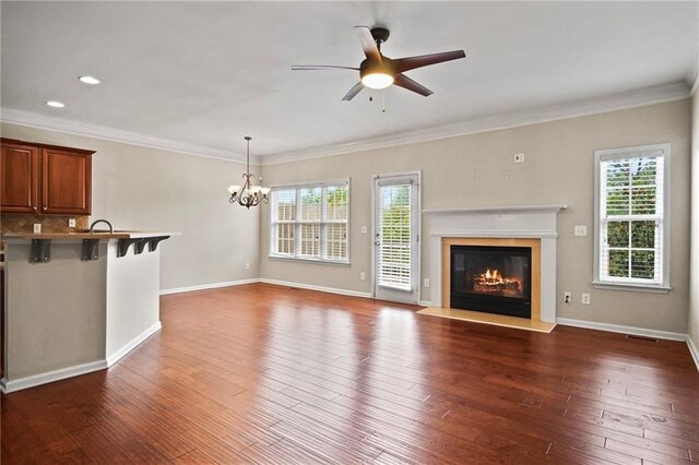 unfurnished living room featuring ceiling fan with notable chandelier, ornamental molding, dark hardwood / wood-style floors, and sink