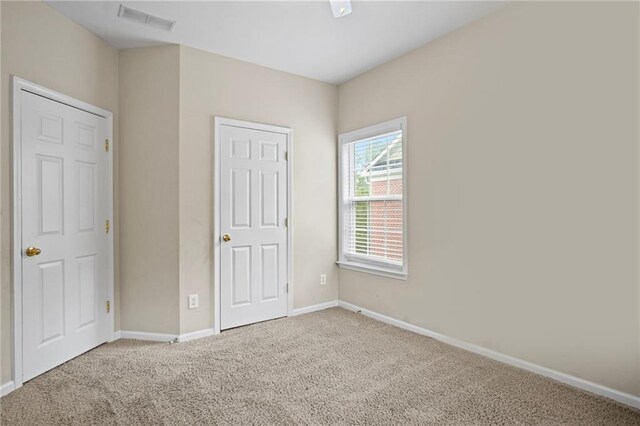 unfurnished bedroom featuring carpet flooring