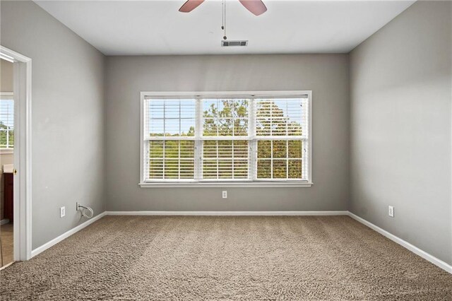 carpeted empty room featuring ceiling fan