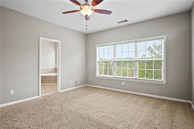 unfurnished room featuring ceiling fan and carpet