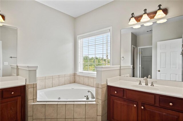 bathroom with independent shower and bath, vanity, and plenty of natural light