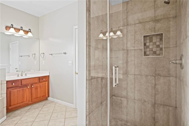 bathroom with tile patterned floors, a shower with door, and vanity