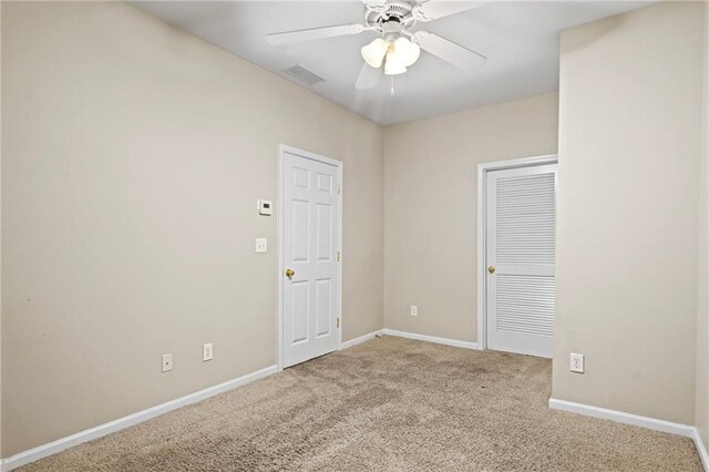 carpeted empty room with ceiling fan