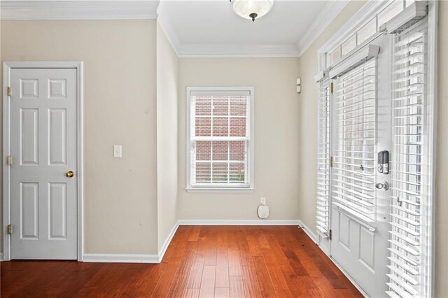 interior space with ornamental molding and dark wood-type flooring