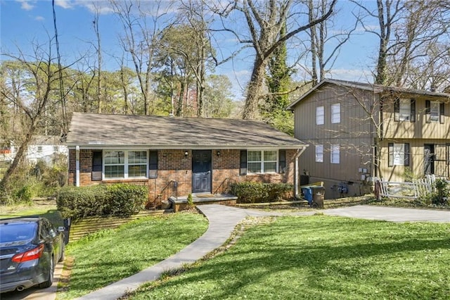 view of front of property with a front lawn and brick siding