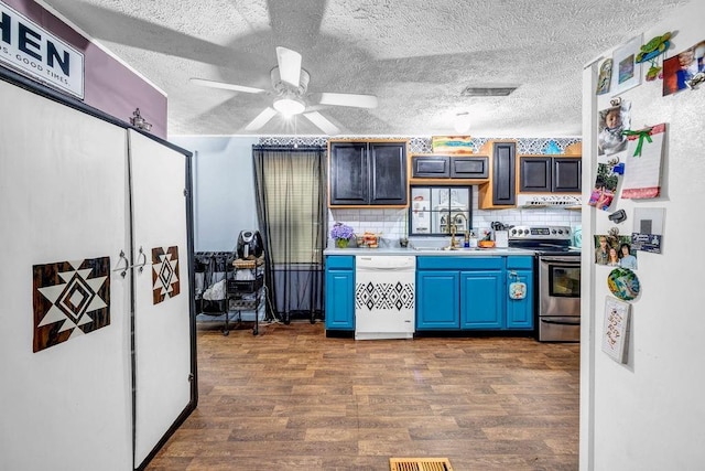 131 W Blue Branch Rd, Eatonton, GA 31024 - kitchen featuring white appliances, blue cabinetry, light countertops, dark wood-style flooring, and a textured ceiling